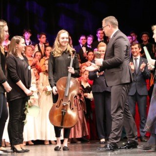 członkini zespołu ARS DECORUM z skrzypcami odbiera nagrodę brązowe harfy w towarzystwie tłumu osób